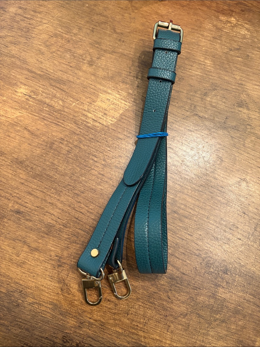 green leather bag strap